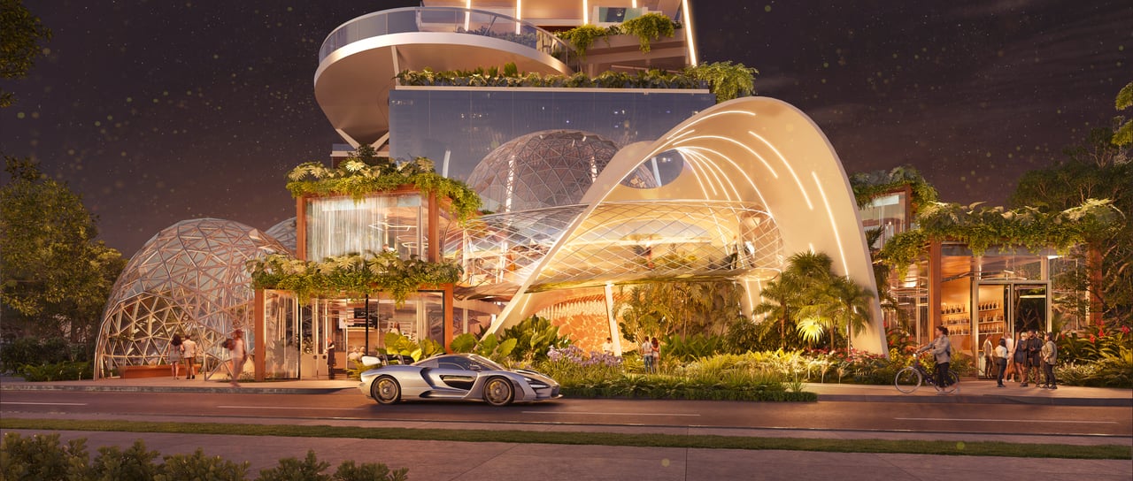 Embasamento da Senna Tower à noite, com arquitetura orgânica e um carro esportivo McLaren em referência a Ayrton Senna